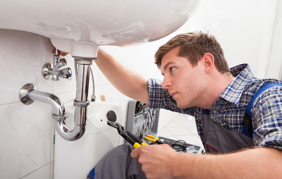 Two plumbers working